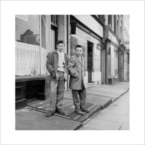 Two young 'teddy boys' pose in the street: 1960