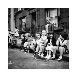 Children sitting on the curb, Maida Vale: 1960
