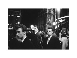Passers-by on a London street at night c.1955