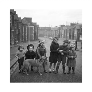 Children gathered in street with dog. c.1955