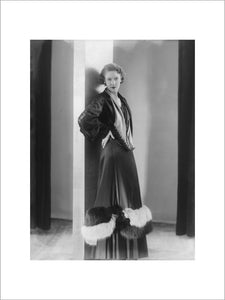 Image of a woman modeling a an evening coat; 1932